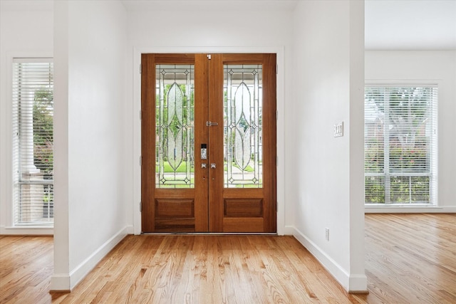 4521 Palmetto St, Bellaire, TX 77401 - foyer with french doors, light wood-style floors, and baseboards