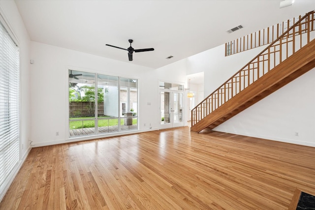 4521 Palmetto St, Bellaire, TX 77401 - unfurnished living room with wood finished floors, ceiling fan, stairway, and baseboards