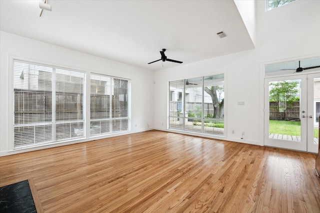 4521 Palmetto St, Bellaire, TX 77401 - unfurnished living room with a ceiling fan, light wood-type flooring, and baseboards