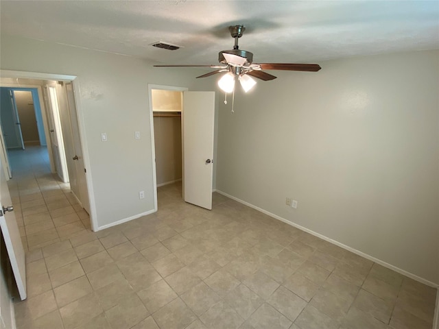10123 Kent Towne Ln, Sugar Land, TX 77498 - unfurnished bedroom with baseboards, ceiling fan, and a spacious closet