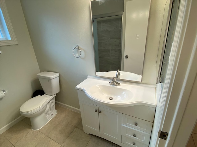 10123 Kent Towne Ln, Sugar Land, TX 77498 - bathroom featuring baseboards, toilet, vanity, and tile patterned flooring