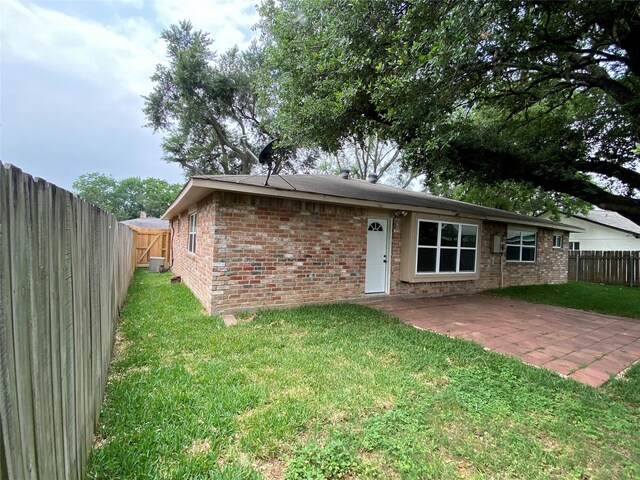 10123 Kent Towne Ln, Sugar Land, TX 77498 - rear view of house featuring brick siding, a patio, and central air condition unit