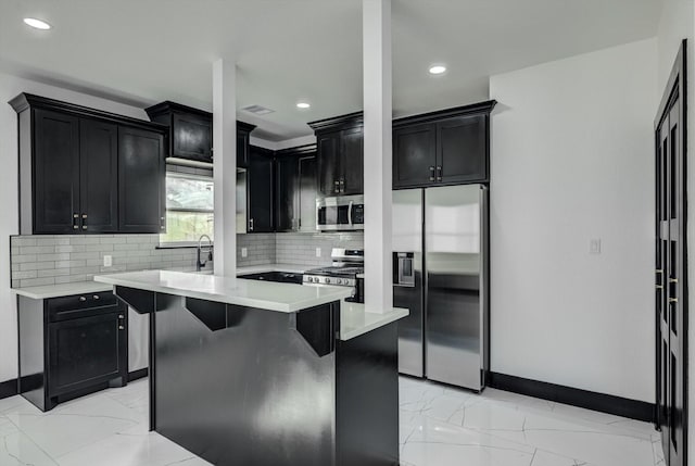5911 Rietta, Houston, TX 77016 - kitchen with appliances with stainless steel finishes, light marble finish flooring, dark cabinets, backsplash, and recessed lighting