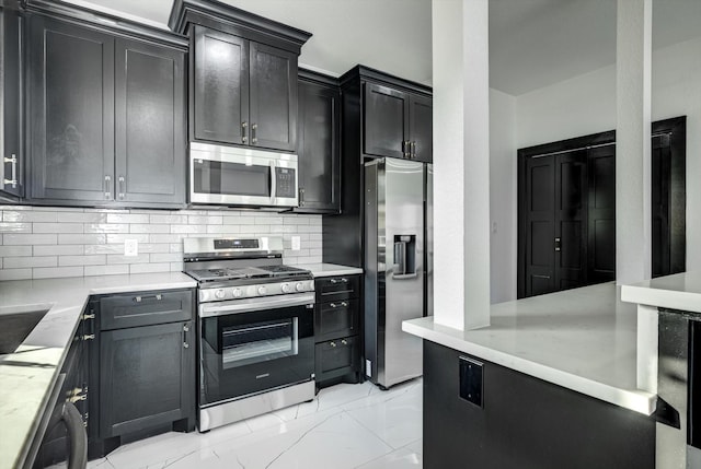 5911 Rietta, Houston, TX 77016 - kitchen with stainless steel appliances, light marble finish flooring, tasteful backsplash, and dark cabinets