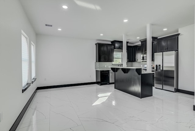 5911 Rietta, Houston, TX 77016 - kitchen with appliances with stainless steel finishes, dark cabinetry, light countertops, decorative backsplash, and recessed lighting