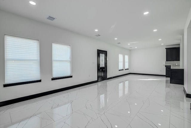5911 Rietta, Houston, TX 77016 - spare room featuring light marble finish flooring and recessed lighting