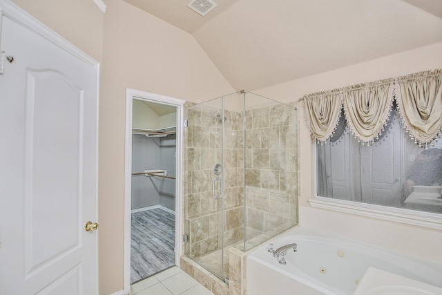 21323 Hannover Frst, Spring, TX 77388 - full bath featuring a shower stall, a tub with jets, vaulted ceiling, a spacious closet, and tile patterned floors