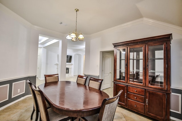 21323 Hannover Frst, Spring, TX 77388 - dining space featuring a chandelier, light tile patterned floors, arched walkways, and ornamental molding
