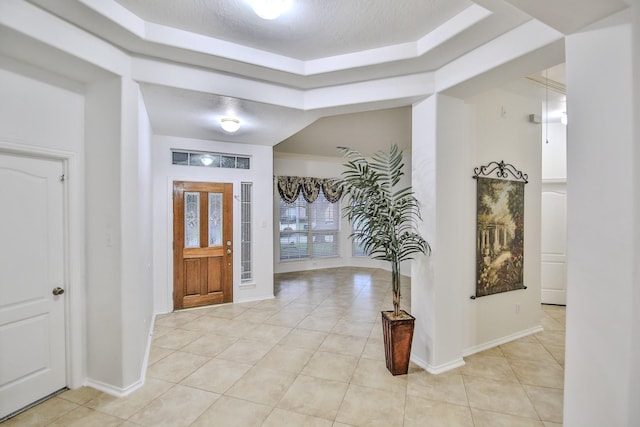 21323 Hannover Frst, Spring, TX 77388 - foyer featuring a raised ceiling, light tile patterned floors, and baseboards
