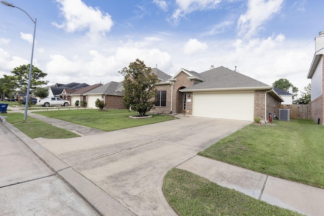 6431 Bright Falls Ln, Katy, TX 77449 - single story home with brick siding, an attached garage, concrete driveway, central AC, and roof with shingles
