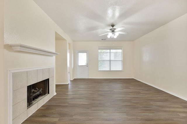 6431 Bright Falls Ln, Katy, TX 77449 - unfurnished living room with ceiling fan, a fireplace, wood finished floors, and baseboards