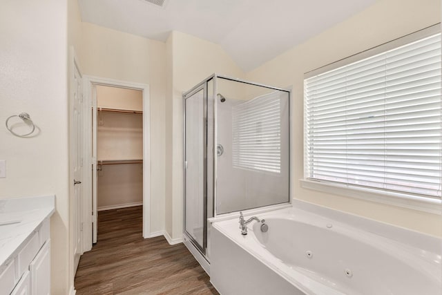 6431 Bright Falls Ln, Katy, TX 77449 - full bathroom featuring a stall shower, a jetted tub, wood finished floors, a walk in closet, and vanity