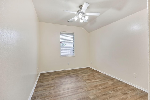 6431 Bright Falls Ln, Katy, TX 77449 - empty room with baseboards, wood finished floors, a ceiling fan, and lofted ceiling