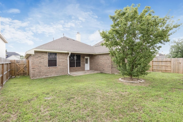 6431 Bright Falls Ln, Katy, TX 77449 - back of house with brick siding, a patio area, roof with shingles, and a chimney