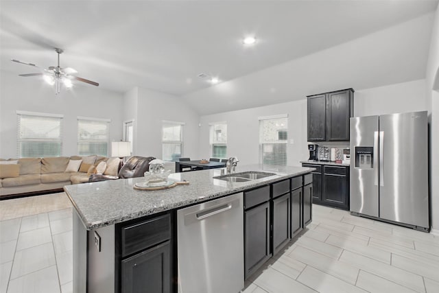 15322 Laceleaf Trl, Houston, TX 77044 - kitchen featuring appliances with stainless steel finishes, lofted ceiling, a sink, an island with sink, and healthy amount of natural light