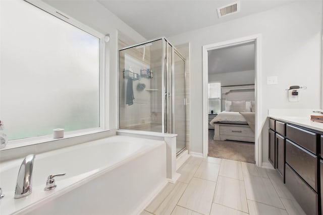 15322 Laceleaf Trl, Houston, TX 77044 - full bathroom featuring a stall shower, a garden tub, ensuite bathroom, vanity, and tile patterned floors