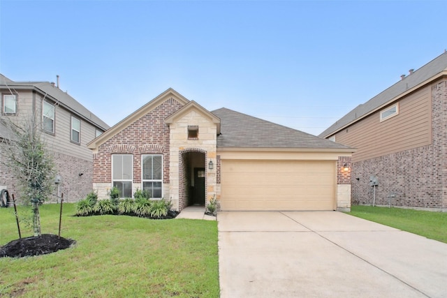 15322 Laceleaf Trl, Houston, TX 77044 - view of front of home with an attached garage, a front yard, concrete driveway, brick siding, and stone siding