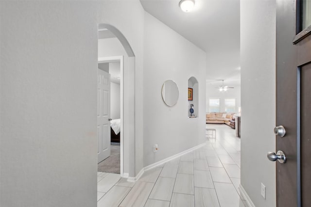15322 Laceleaf Trl, Houston, TX 77044 - corridor featuring arched walkways, light tile patterned floors, and baseboards
