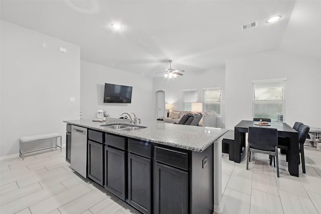15322 Laceleaf Trl, Houston, TX 77044 - kitchen with a sink, light stone counters, stainless steel dishwasher, arched walkways, and a kitchen island with sink