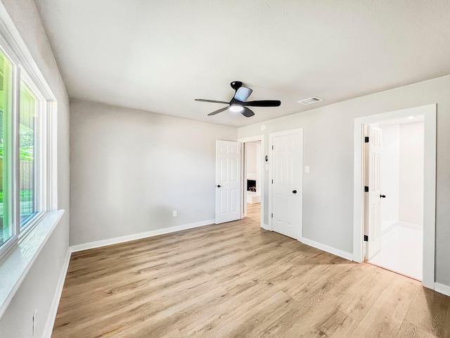 4926 Adonis Dr, Spring, TX 77373 - unfurnished bedroom featuring wood finished floors, baseboards, and ensuite bath