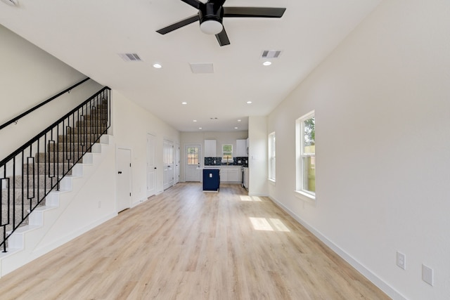 8149 Talton St B, Unit A, Houston, TX 77028 - unfurnished living room featuring light wood finished floors, ceiling fan, stairway, baseboards, and recessed lighting