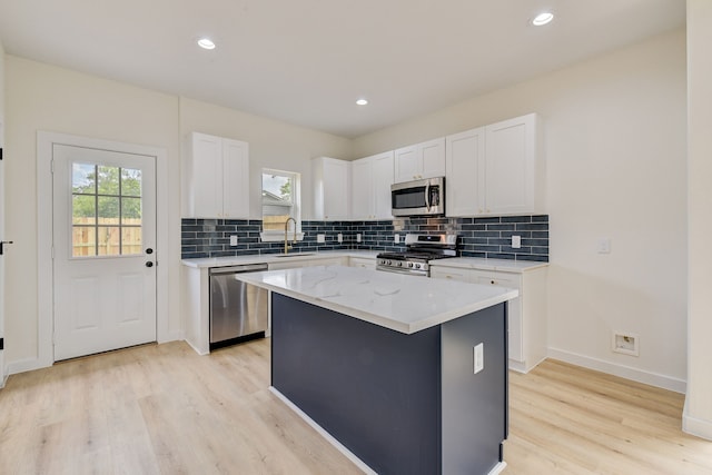 8149 Talton St B, Unit A, Houston, TX 77028 - kitchen featuring appliances with stainless steel finishes, healthy amount of natural light, decorative backsplash, light wood-style floors, and recessed lighting