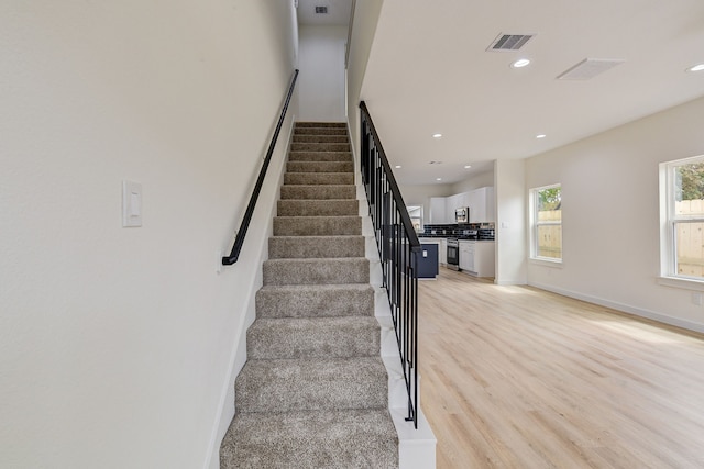 8149 Talton St B, Unit A, Houston, TX 77028 - stairway with recessed lighting, wood finished floors, and baseboards