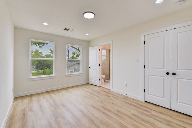8149 Talton St B, Unit A, Houston, TX 77028 - unfurnished bedroom featuring light wood-style flooring, baseboards, recessed lighting, ensuite bath, and a closet