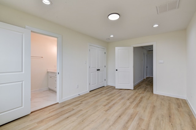 8149 Talton St B, Unit A, Houston, TX 77028 - unfurnished bedroom featuring light wood-style flooring, baseboards, recessed lighting, and ensuite bath