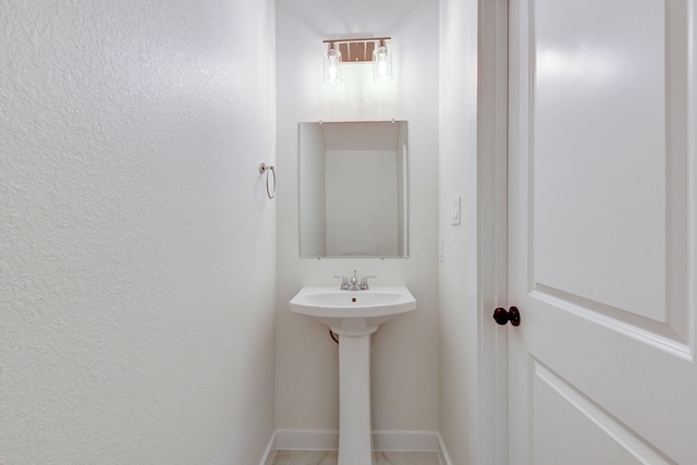 8149 Talton St B, Unit A, Houston, TX 77028 - bathroom featuring baseboards and a textured wall
