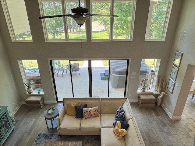 201 Deen Dr, Houston, TX 77336 - living area with wood finished floors, a towering ceiling, healthy amount of natural light, and baseboards