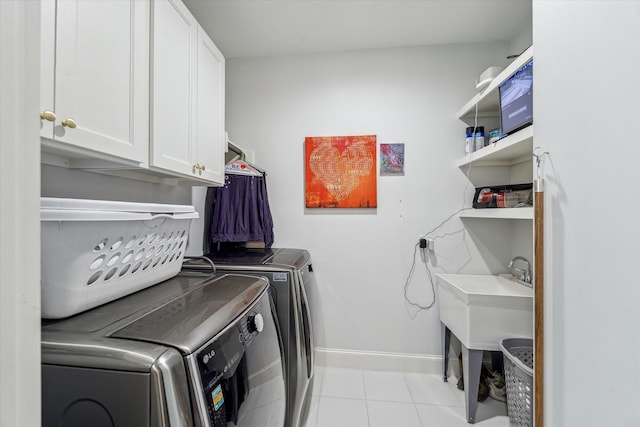 1212 Bingham St, Houston, TX 77007 - laundry room featuring cabinet space, washer and clothes dryer, baseboards, and light tile patterned floors