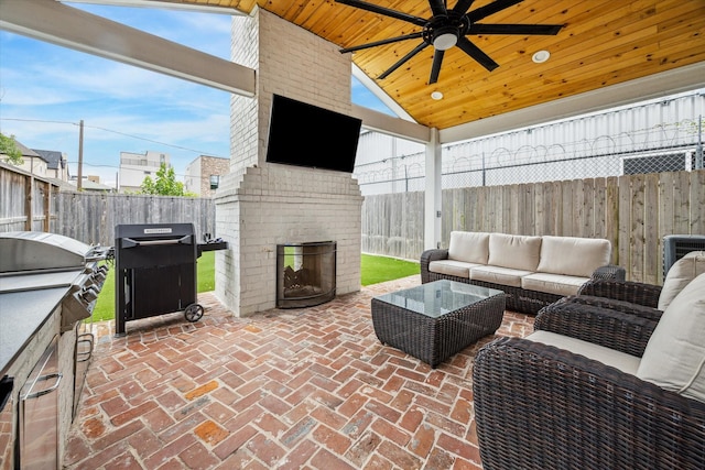 1212 Bingham St, Houston, TX 77007 - fenced backyard with a patio, a ceiling fan, an outdoor living space with a fireplace, and area for grilling