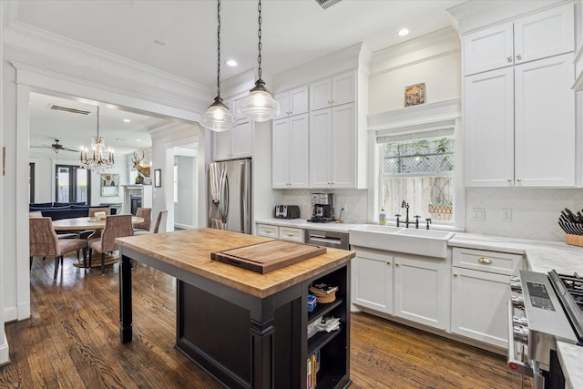 1212 Bingham St, Houston, TX 77007 - kitchen with stainless steel appliances, butcher block countertops, white cabinetry, ornamental molding, and open shelves