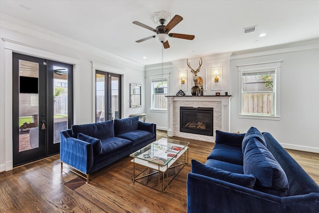 1212 Bingham St, Houston, TX 77007 - living room featuring french doors, ornamental molding, a glass covered fireplace, a ceiling fan, and wood finished floors