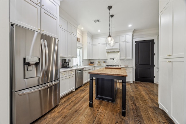 1212 Bingham St, Houston, TX 77007 - kitchen with appliances with stainless steel finishes, wood counters, a sink, dark wood-style floors, and white cabinetry