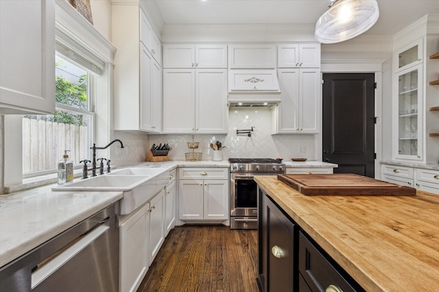 1212 Bingham St, Houston, TX 77007 - kitchen featuring butcher block counters, appliances with stainless steel finishes, white cabinets, a sink, and glass insert cabinets