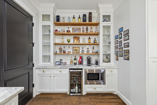 1212 Bingham St, Houston, TX 77007 - indoor dry bar with wine cooler, stainless steel microwave, crown molding, dark wood-style floors, and decorative backsplash