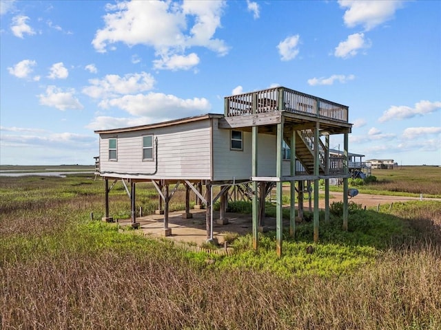 227 Detenbeck Ave, Surfside Beach, TX 77541 - rear view of house featuring a deck and stairs