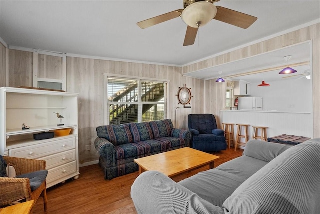227 Detenbeck Ave, Surfside Beach, TX 77541 - living area with healthy amount of natural light, wood finished floors, a ceiling fan, and crown molding