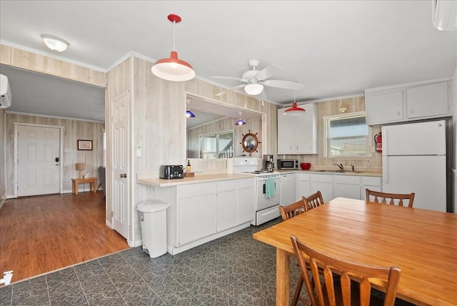 227 Detenbeck Ave, Surfside Beach, TX 77541 - kitchen with white appliances, a sink, a ceiling fan, white cabinets, and pendant lighting