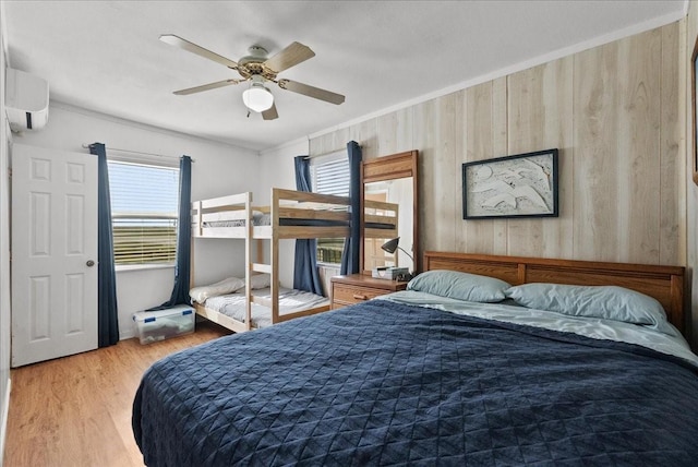 227 Detenbeck Ave, Surfside Beach, TX 77541 - bedroom with wood finished floors, an AC wall unit, crown molding, a ceiling fan, and wood walls