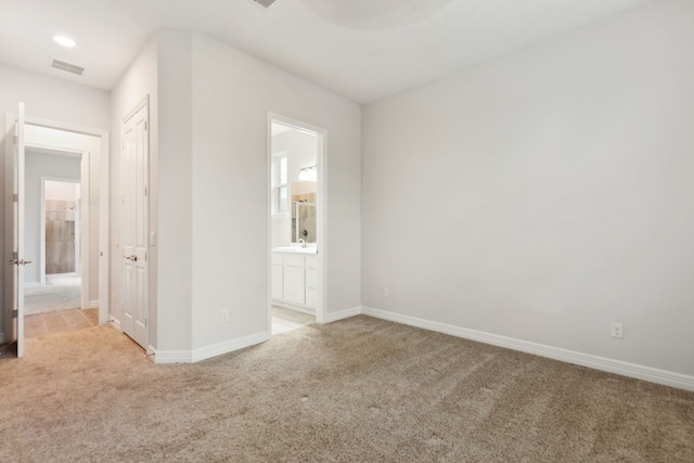 5204 Andorra Bend Ln, Porter, TX 77365 - unfurnished bedroom with light carpet, baseboards, and ensuite bath