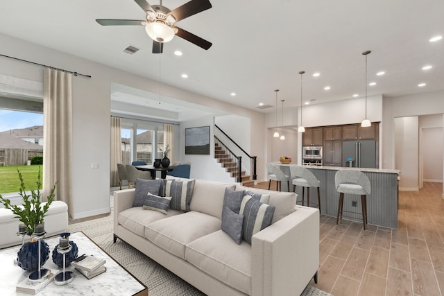 5204 Andorra Bend Ln, Porter, TX 77365 - living area with recessed lighting, stairs, baseboards, a ceiling fan, and light wood-style flooring