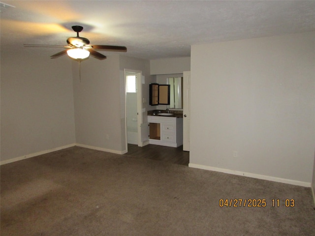 16114 Forest Bend Ave, Friendswood, TX 77546 - unfurnished living room featuring dark carpet, a ceiling fan, baseboards, and a sink