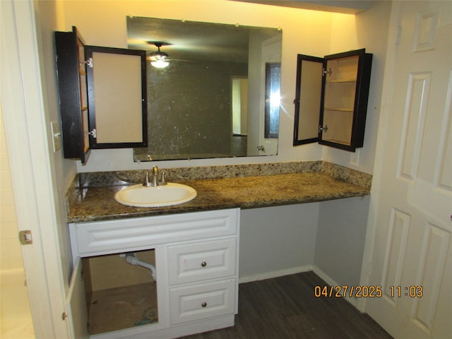 16114 Forest Bend Ave, Friendswood, TX 77546 - bathroom featuring vanity, wood finished floors, baseboards, and a ceiling fan
