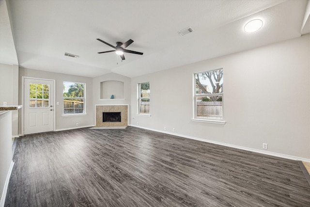 10410 Caribou Cv, Missouri City, TX 77459 - unfurnished living room featuring dark wood-type flooring, ceiling fan, baseboards, and a fireplace