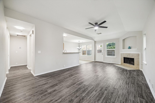 10410 Caribou Cv, Missouri City, TX 77459 - unfurnished living room with a ceiling fan, dark wood-style flooring, a tile fireplace, and baseboards