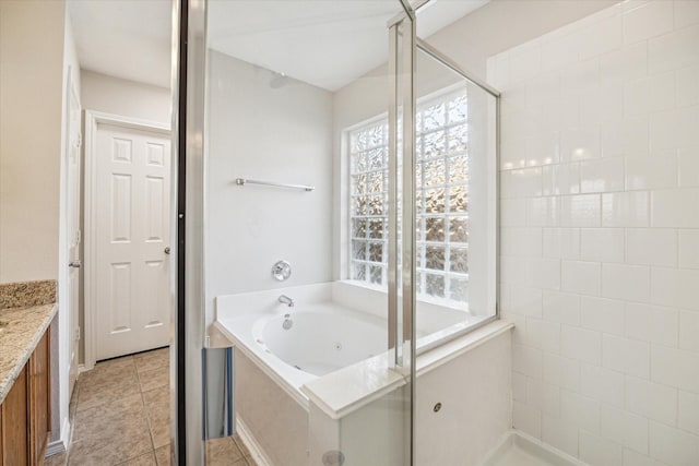 10410 Caribou Cv, Missouri City, TX 77459 - bathroom featuring a tub with jets, a stall shower, vanity, and tile patterned floors