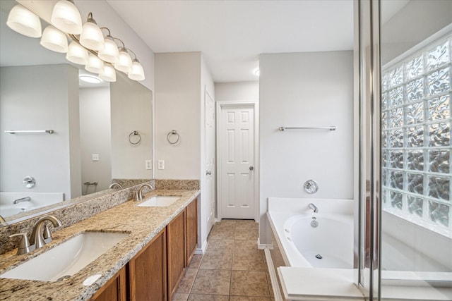 10410 Caribou Cv, Missouri City, TX 77459 - bathroom featuring a bath, double vanity, and tile patterned floors